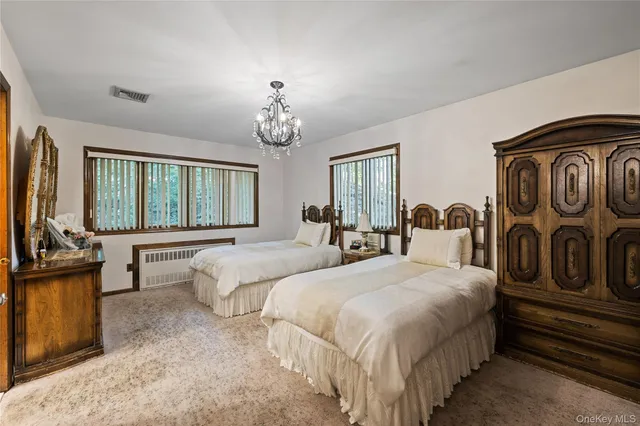 a spacious bedroom with a bed a couch and dresser