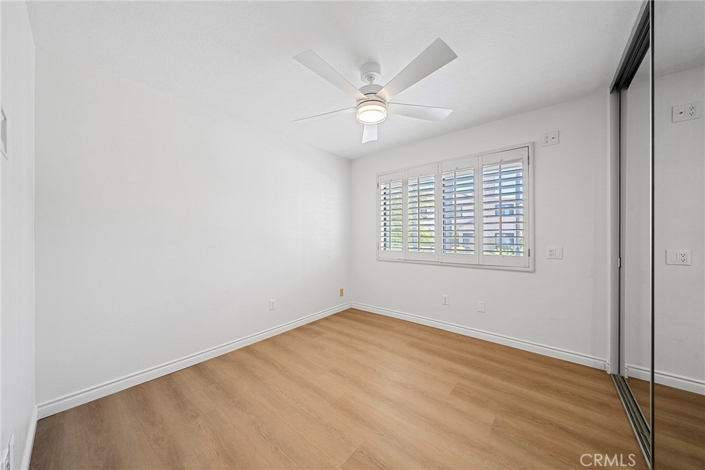 4277-1 Las Virgenes Road Calabasas, CA 91302 - Photo 16 of 28 Second bedroom has spacious closet with custom organizers and sliding mirror doors. Plantation shutters and a ceiling fan.