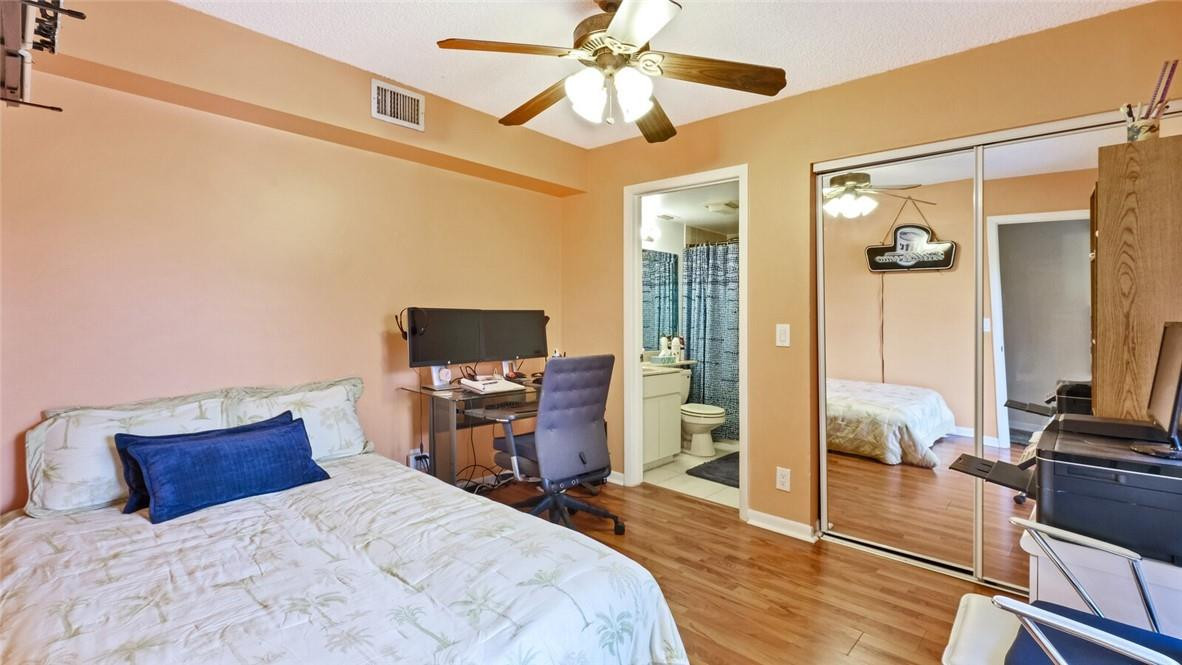 8146 Thames Boulevard, Unit A Boca Raton, FL 33433 - Photo 10 of 18 a bedroom with a bed and wooden floor