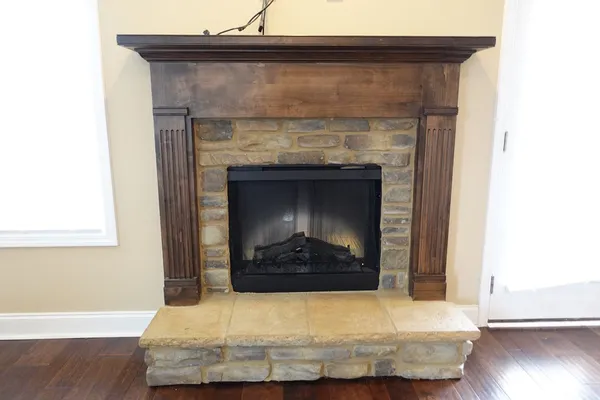 a living room with a fireplace and a wooden floor