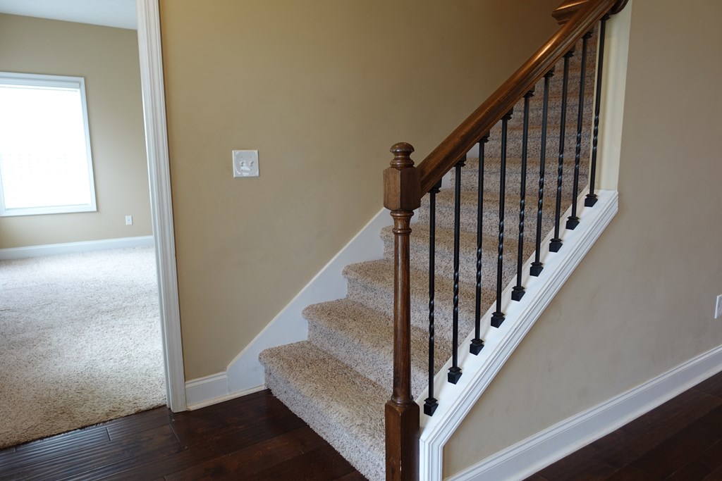 9981 Coppice Court Midland, GA 31820 - Photo 17 of 33 a view of staircase with wooden floor and white walls