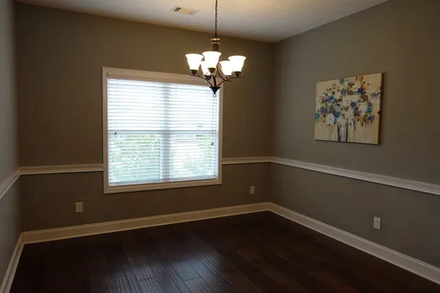 a view of wooden floor and windows in a room