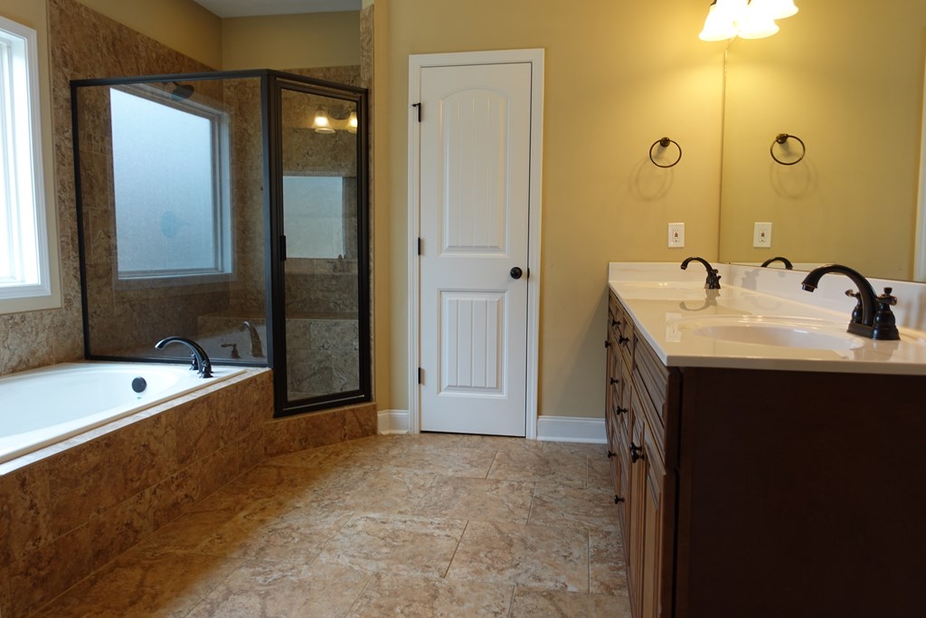 9981 Coppice Court Midland, GA 31820 - Photo 21 of 33 a bathroom with a tub sink and mirror