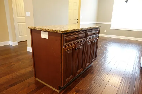 a view of a kitchen with wooden floor and a sink