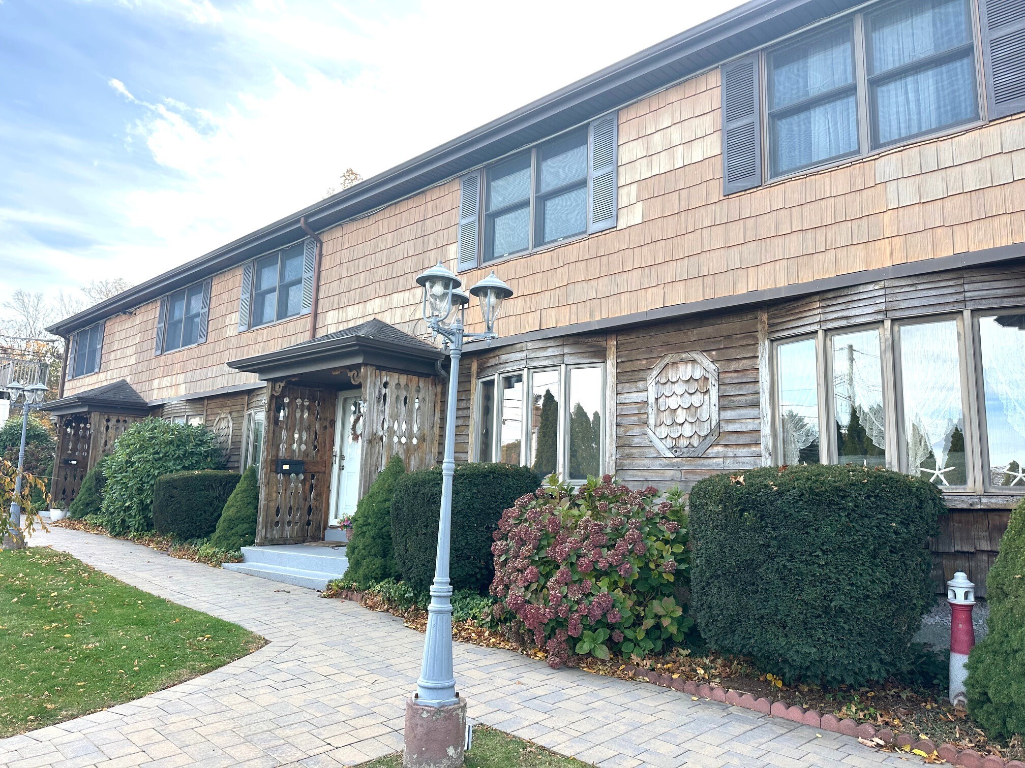 a front view of a house with garden