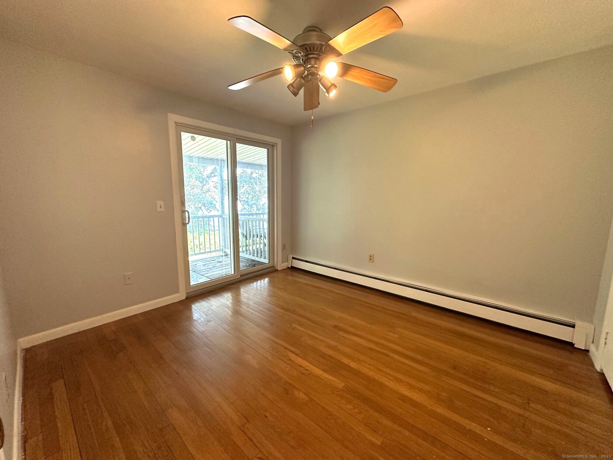 1 Cora Street, Unit 4 New Haven, CT 06512 - Photo 11 of 22 a view of an empty room with window and wooden floor