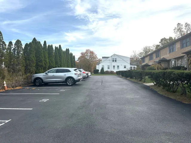 a view of a car parked on the side of the street