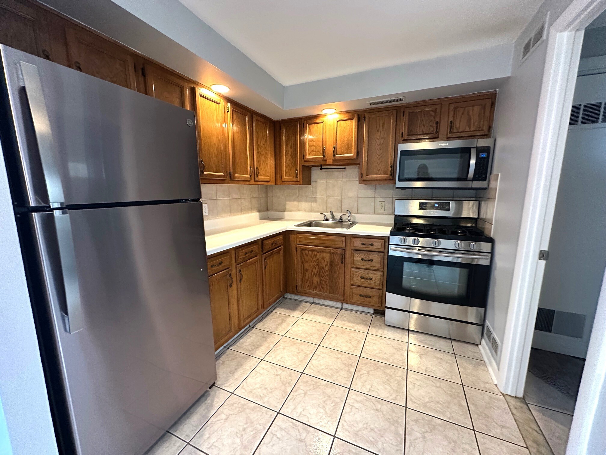 1 Cora Street, Unit 4 New Haven, CT 06512 - Photo 7 of 22 a kitchen with stainless steel appliances a refrigerator sink and cabinets