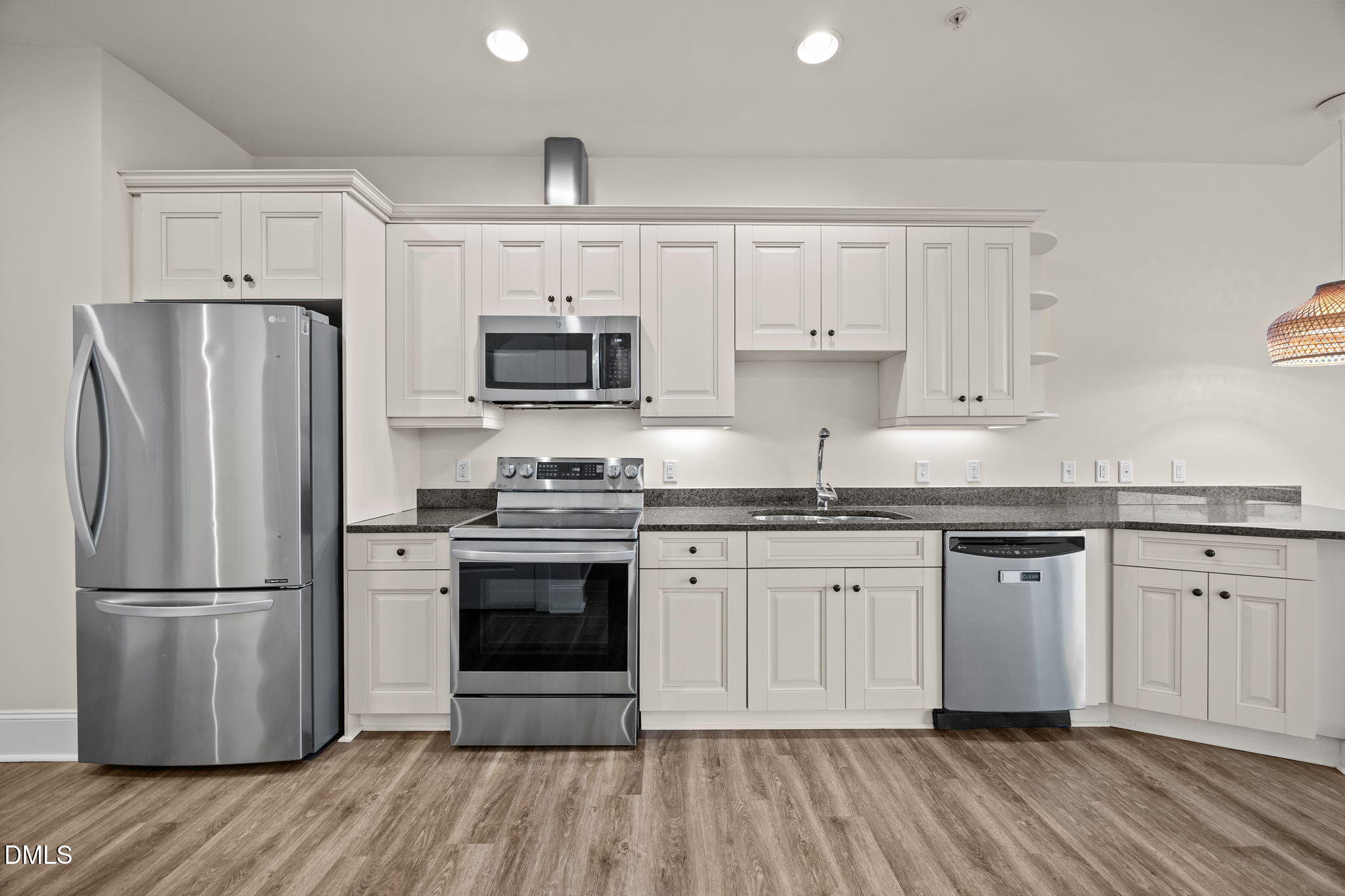 400 West North Street, Unit 814 Raleigh, NC 27603 - Photo 16 of 41 a kitchen with granite countertop a refrigerator stove top oven and sink