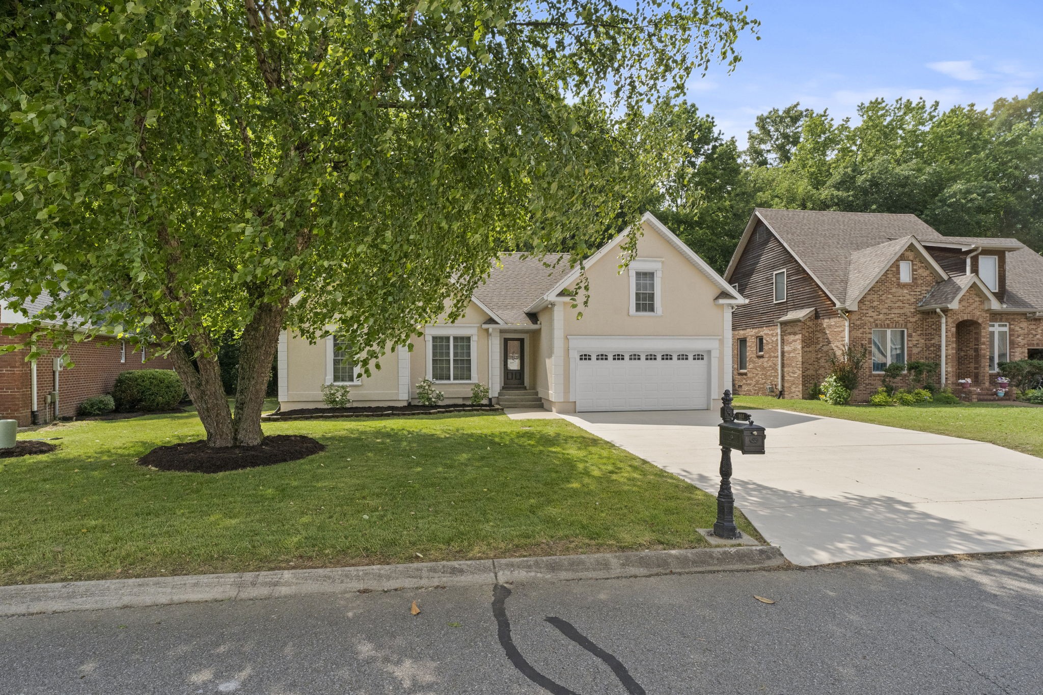 164 Foxrun Springfield, TN 37172 - Photo 1 of 37 a front view of a house with a garden and trees