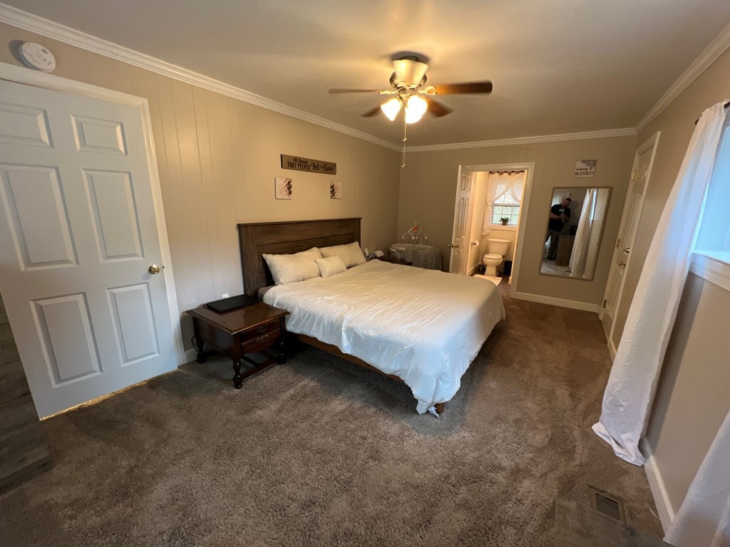 2050 Old River Road Charleston, TN 37310 - Photo 11 of 64 a bedroom with a bed and a chandelier