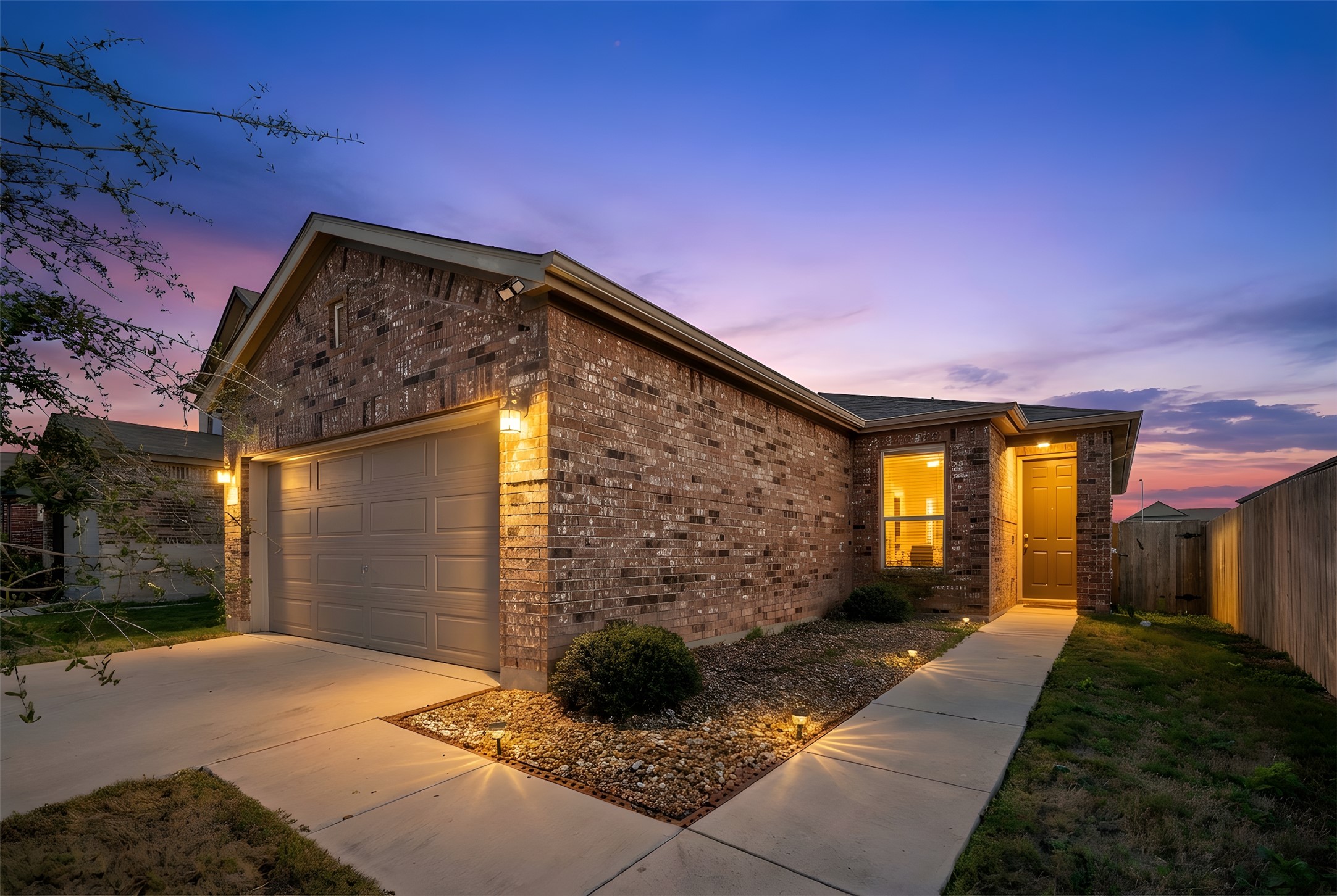13917 Inaugural Street Manor, TX 78653 - Photo 4 of 39 View of front of property with brick siding, concrete driveway, and an attached garage