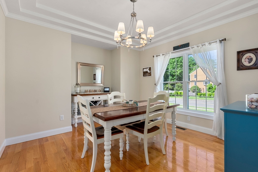 63 Vista Circle Holden, MA 01520 - Photo 12 of 36 a view of a dining room with furniture a chandelier and wooden floor