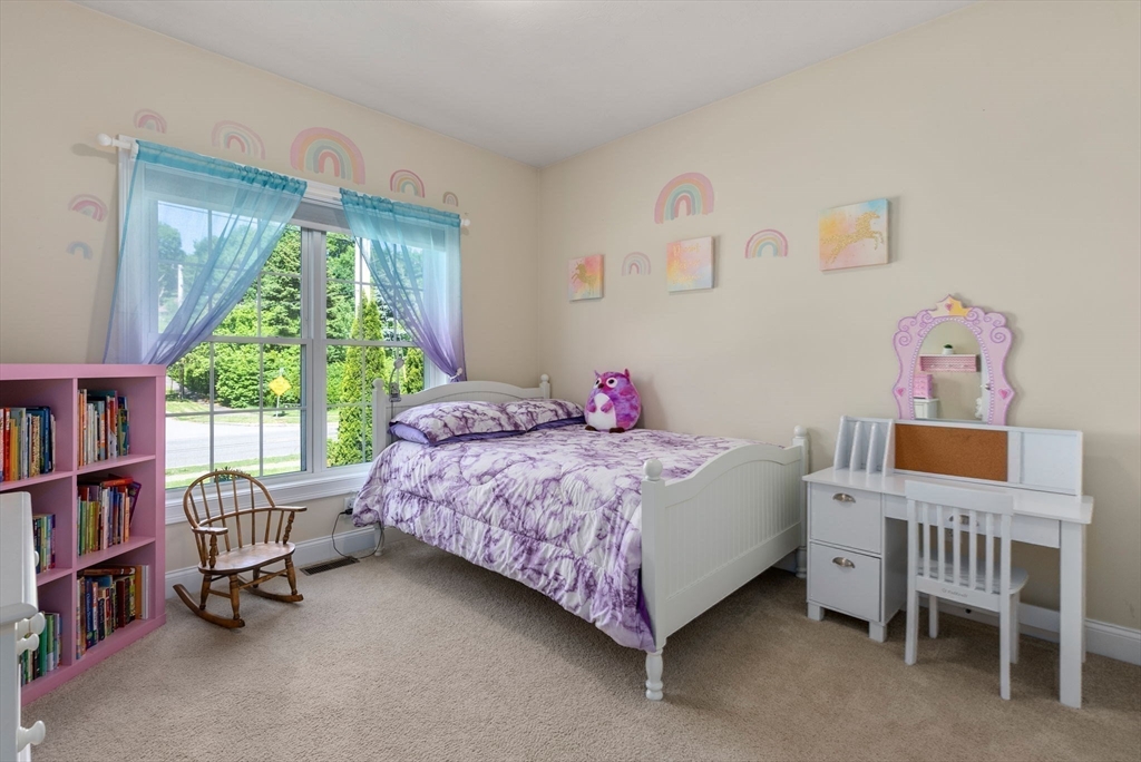63 Vista Circle Holden, MA 01520 - Photo 22 of 36 a bedroom with a bed book shelf and a window