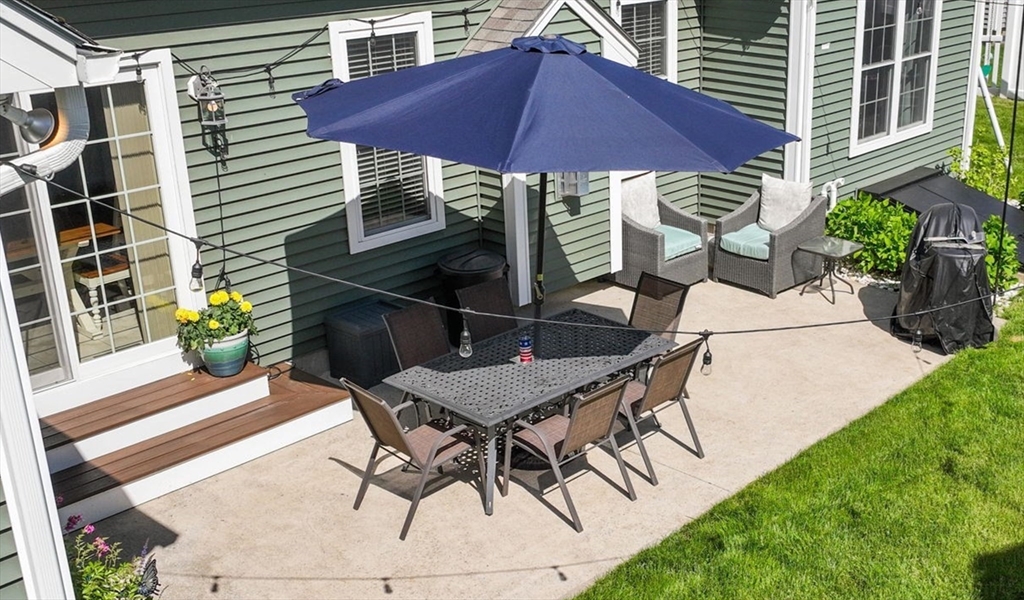 63 Vista Circle Holden, MA 01520 - Photo 32 of 36 a view of a patio with table and chairs under an umbrella