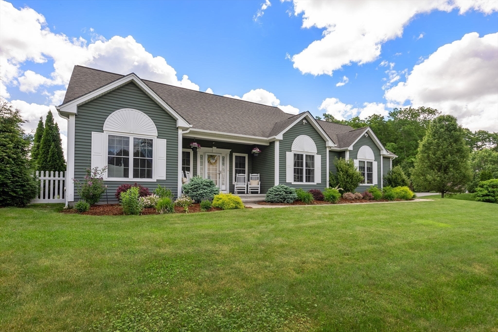 63 Vista Circle Holden, MA 01520 - Photo 4 of 36 a front view of a house with a garden and porch