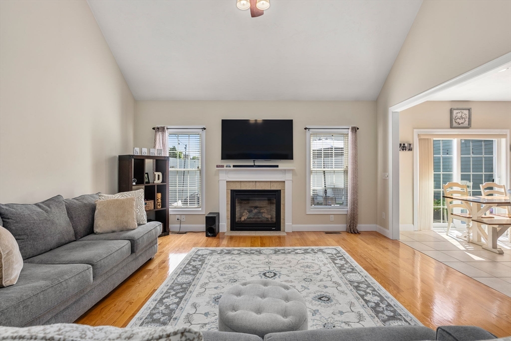 63 Vista Circle Holden, MA 01520 - Photo 6 of 36 a living room with furniture a flat screen tv and a fireplace
