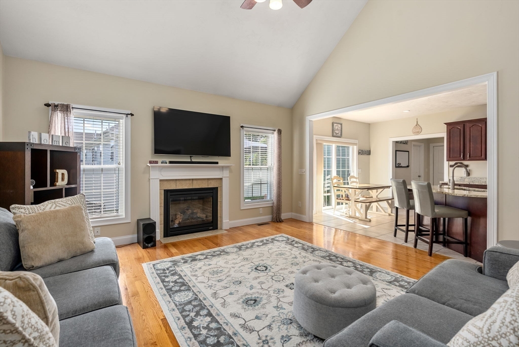 63 Vista Circle Holden, MA 01520 - Photo 8 of 36 a living room with furniture a flat screen tv and a fireplace