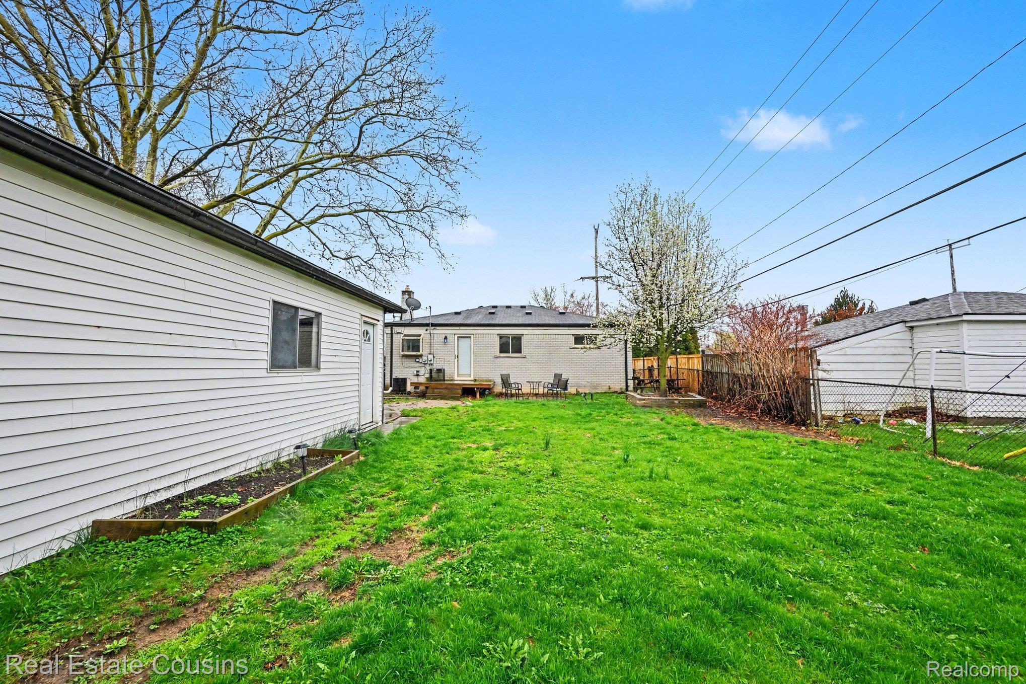 32224 Joy Road Livonia, MI 48150 - Photo 25 of 33 Fenced backyard featuring a wooden deck