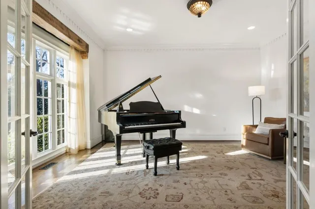 a living room with furniture a chandelier and a fireplace