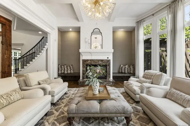 a living room with furniture a window and a potted plant