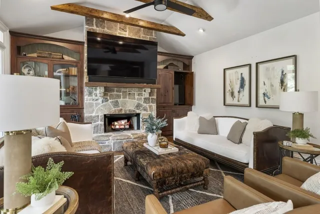 a living room with furniture and a chandelier