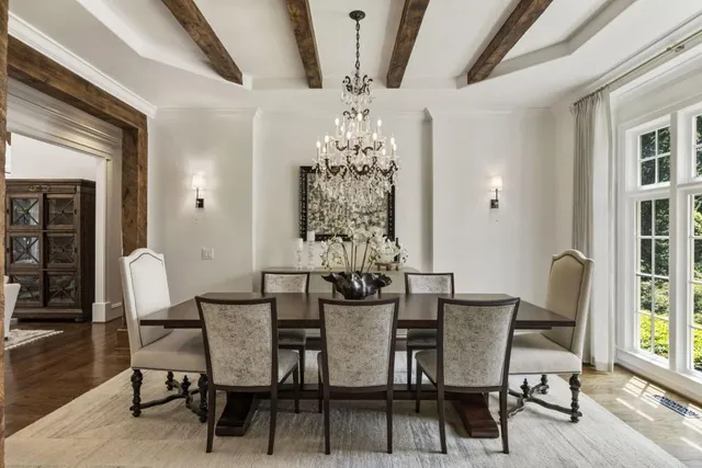 a living room with furniture a fireplace and a floor to ceiling window