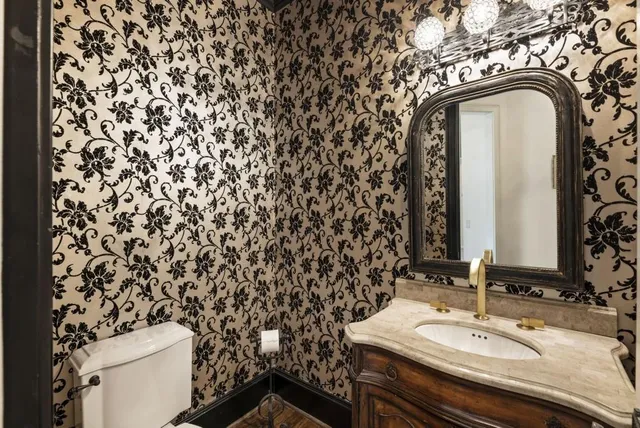 a bathroom with a tub sink and mirror