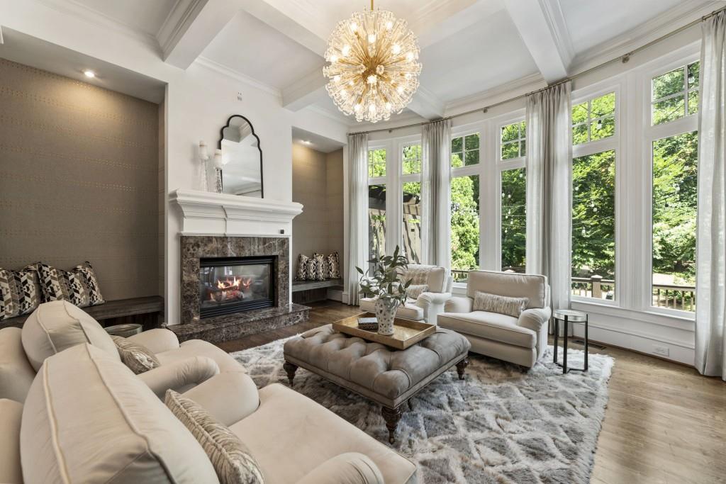 2810 Manor Bridge Drive Milton, GA 30004 - Photo 4 of 70 a living room with furniture a fireplace and a floor to ceiling window