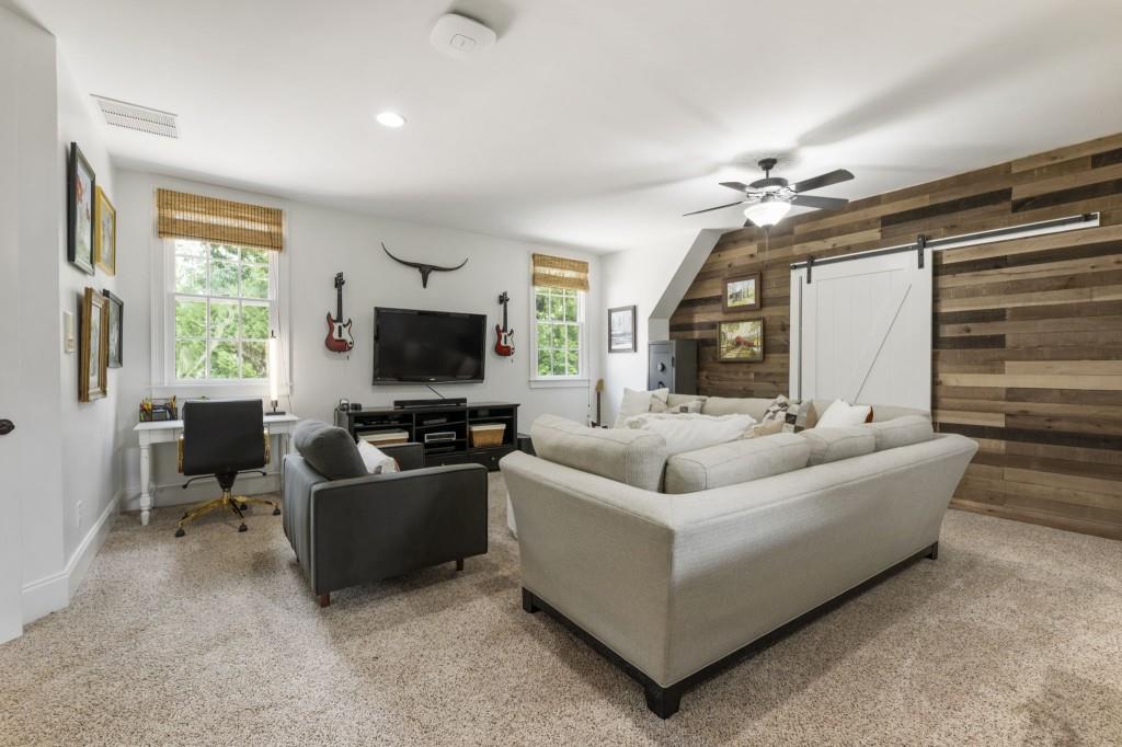 2810 Manor Bridge Drive Milton, GA 30004 - Photo 59 of 70 a living room with furniture and a flat screen tv