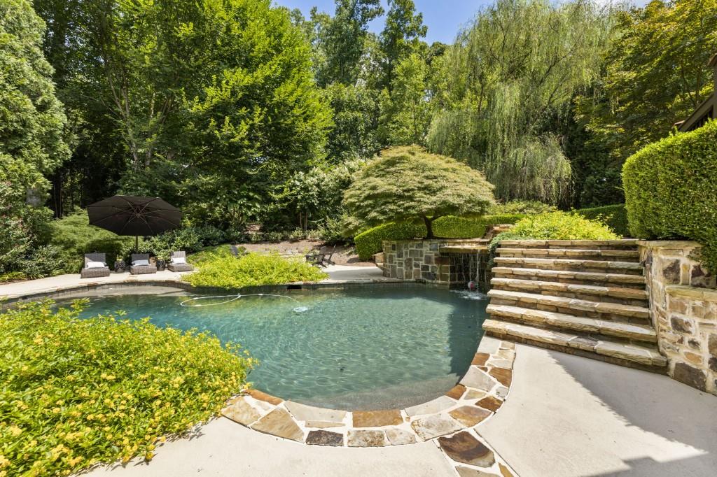 2810 Manor Bridge Drive Milton, GA 30004 - Photo 65 of 70 a view of a swimming pool with a yard and plants