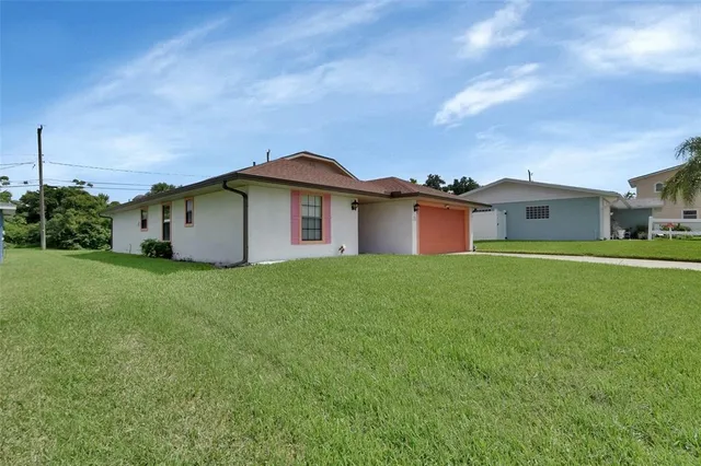 a front view of a house with a garden and yard