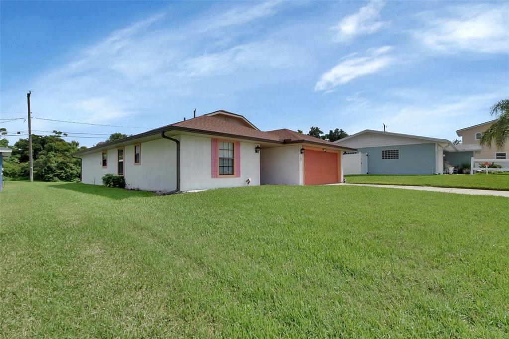 33 Rivocean Drive Ormond Beach, FL 32176 - Photo 21 of 31 a front view of a house with a garden and yard