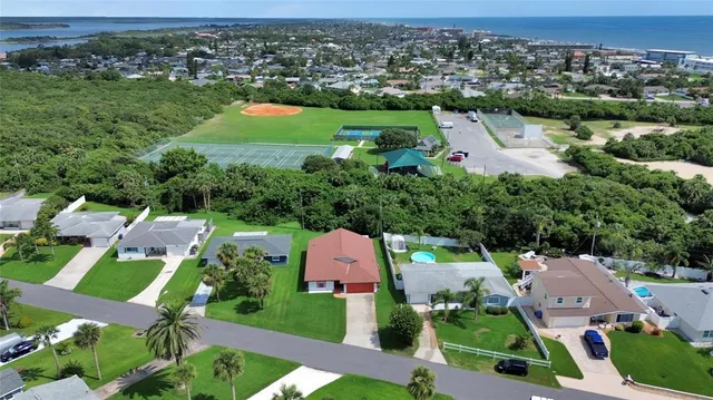 an aerial view of multiple houses with yard