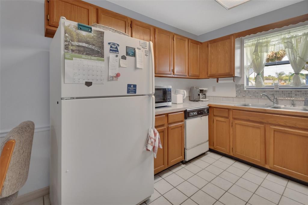 33 Rivocean Drive Ormond Beach, FL 32176 - Photo 5 of 31 a kitchen with stainless steel appliances white cabinets and a refrigerator