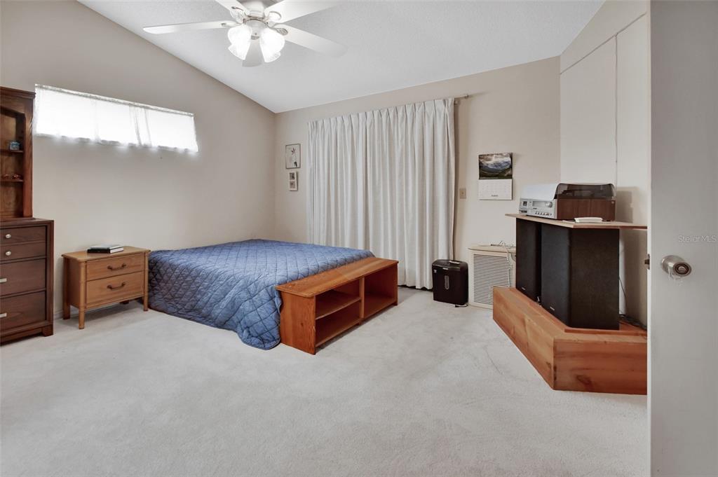 33 Rivocean Drive Ormond Beach, FL 32176 - Photo 7 of 31 a bedroom with a bed and a chandelier