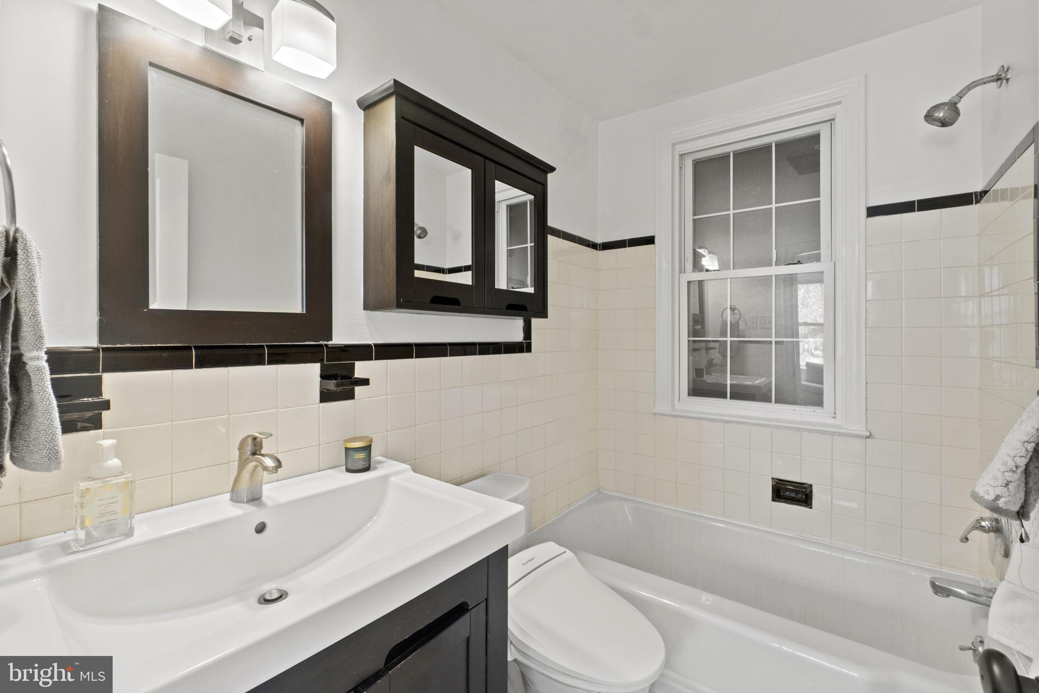 9123 Bradford Road Silver Spring, MD 20901 - Photo 13 of 22 a bathroom with a sink a toilet and shower