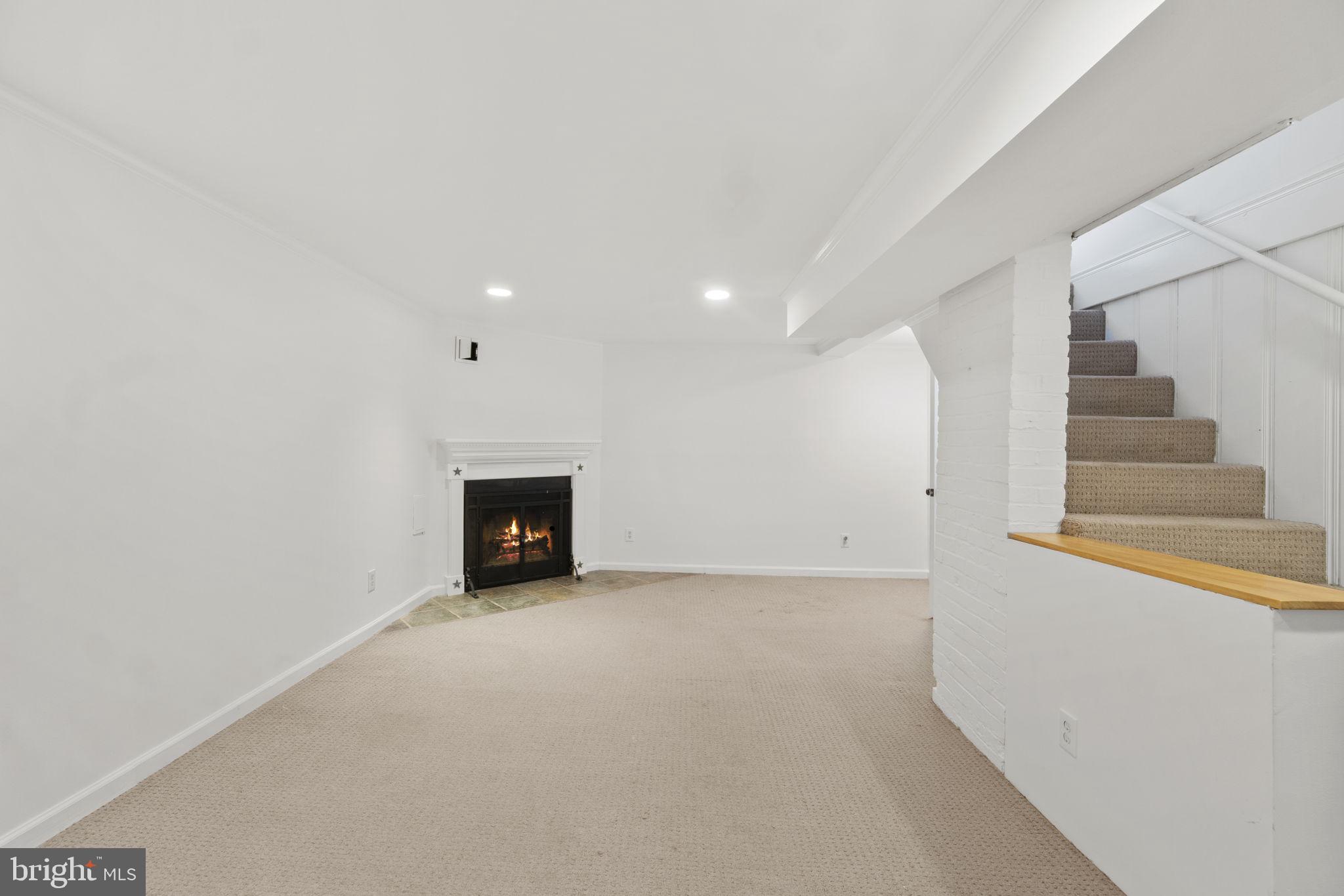 9123 Bradford Road Silver Spring, MD 20901 - Photo 14 of 22 a view of an empty room with a fireplace