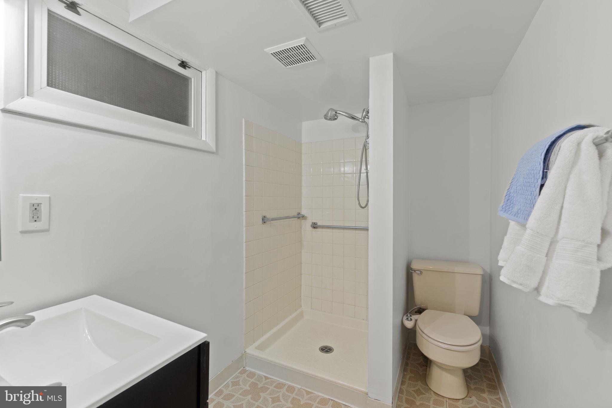 9123 Bradford Road Silver Spring, MD 20901 - Photo 16 of 22 a bathroom with a granite countertop toilet and a sink