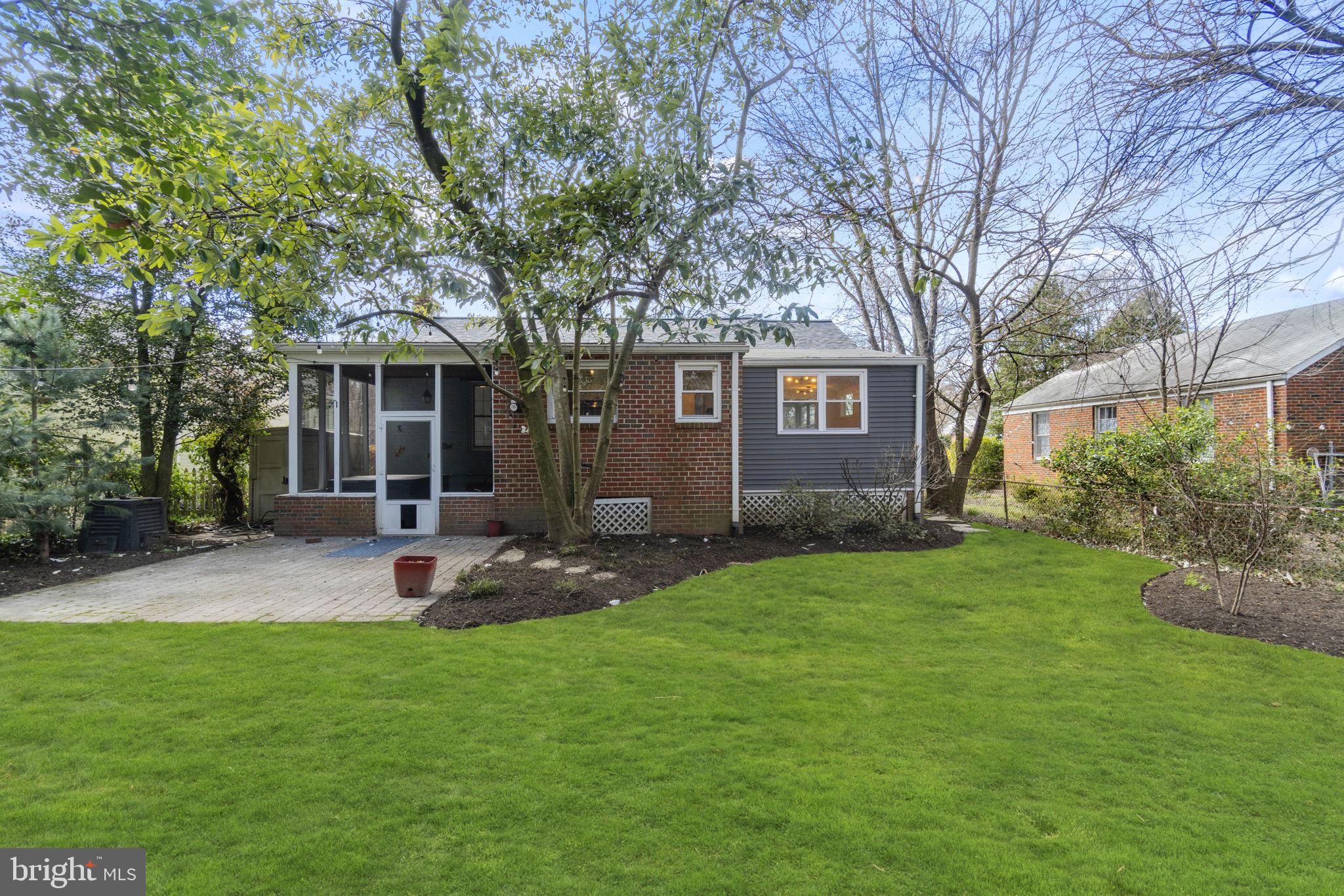 9123 Bradford Road Silver Spring, MD 20901 - Photo 21 of 22 a view of a backyard with table and chairs and large tree