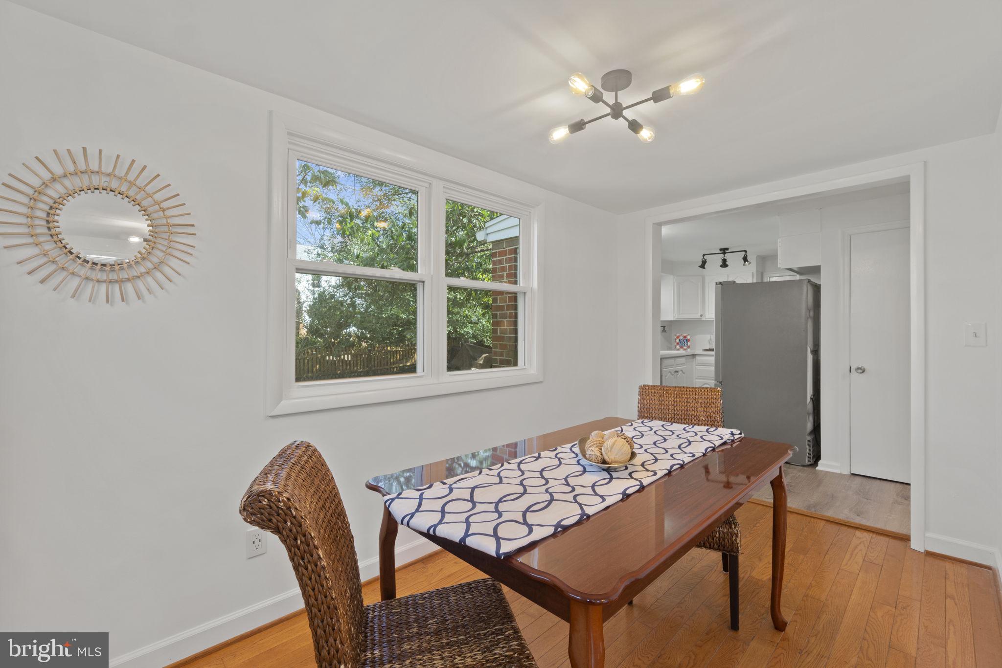 9123 Bradford Road Silver Spring, MD 20901 - Photo 7 of 22 a view of a dining room with furniture and wooden floor