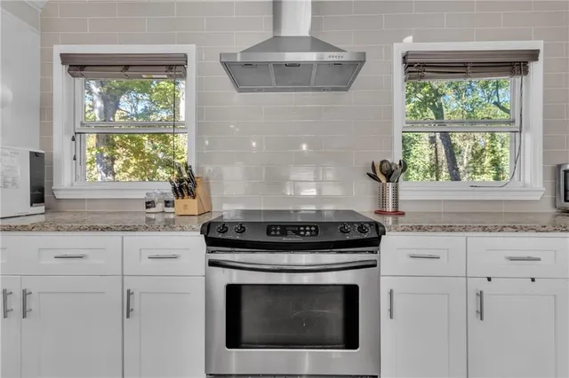 a stove top oven sitting inside of a kitchen