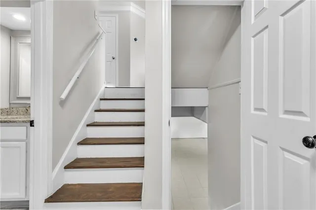 a view of staircase with white walls and a window