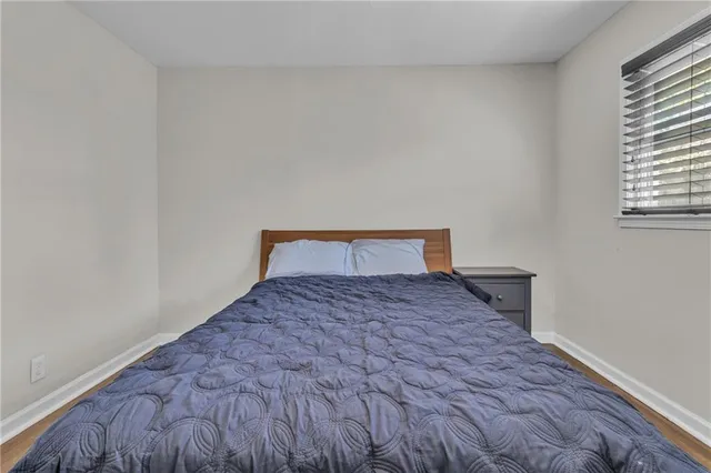 a bedroom with a bed and window