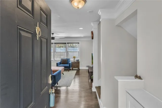 a view of a hallway with couch and chairs