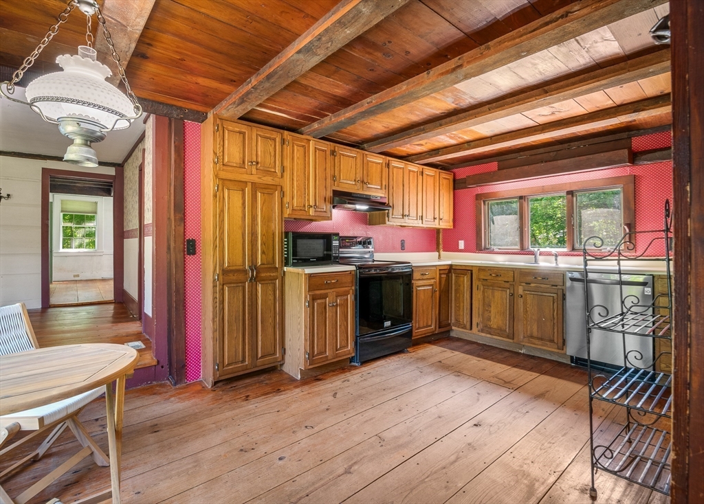 36 Patten Road Merrimack, NH 03054 - Photo 15 of 32 a kitchen that has a sink a stove and wooden floors