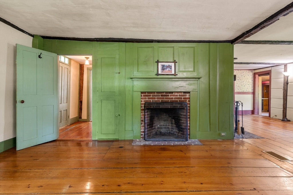 36 Patten Road Merrimack, NH 03054 - Photo 7 of 32 an empty room with wooden floor and a fireplace