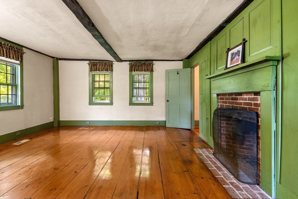 36 Patten Road Merrimack, NH 03054 - Photo 8 of 32 a view of an empty room with wooden floor and a window