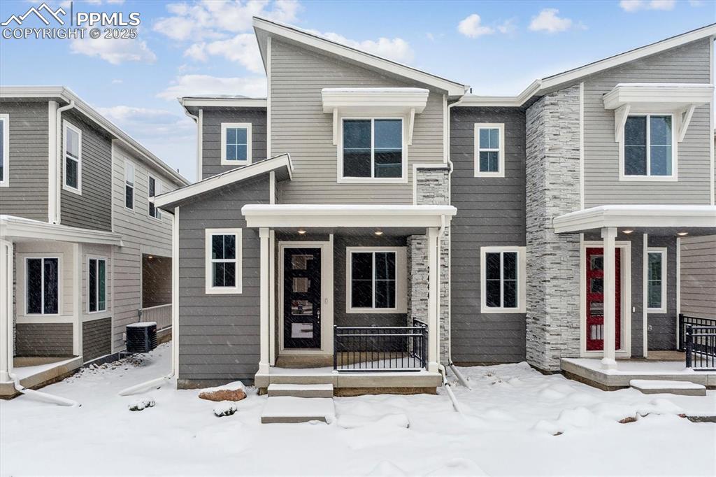 2444 Serviceberry Grove Colorado Springs, CO 80915 - Photo 1 of 21 a view of a house with large windows