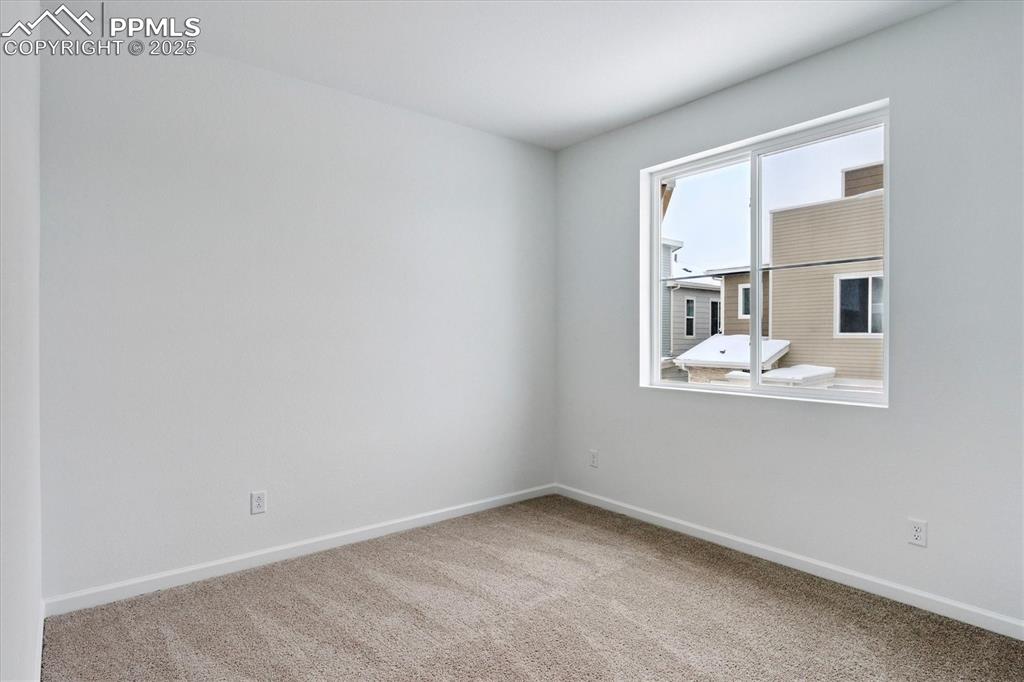 2444 Serviceberry Grove Colorado Springs, CO 80915 - Photo 11 of 21 an empty room with windows